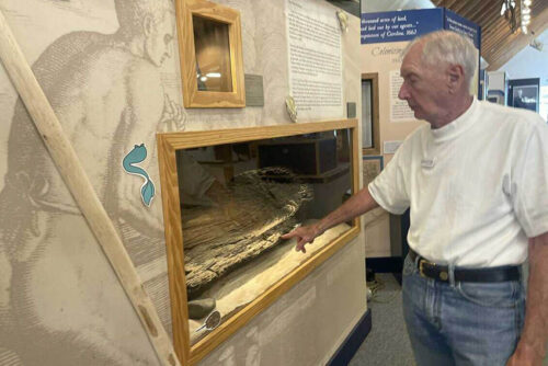 Frank Popelars, a guide at North Carolina Maritime Museum at Southport points to an ancient piece of a canoe that the Cape Fear Indians once used to paddle the waters of the Cape Fear River.