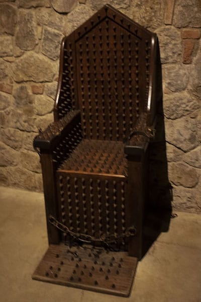 The torture chair. Hard to imagine that ordinary people, people just like the one who went with us on the tour would jump in the lap of someone suffering the torture chair to bring the condemned even more pain. Photo by Adrian Tysoe