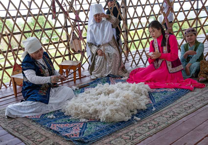 Re-enactors demonstrate the process of carding wool at the Huns' Ethno-village, following in the tradition of their nomadic ancestors.