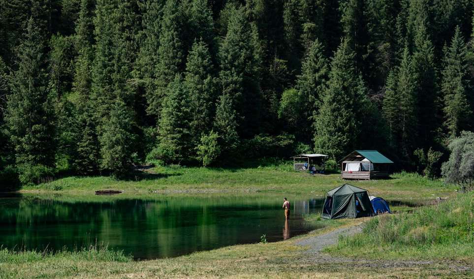 In the Kaiyndy Lake area, locals and visitors can camp, fish, and hike among the pine trees.
