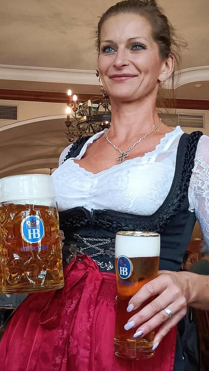 A professional waitress delivering beer at Hofbrauhaus.