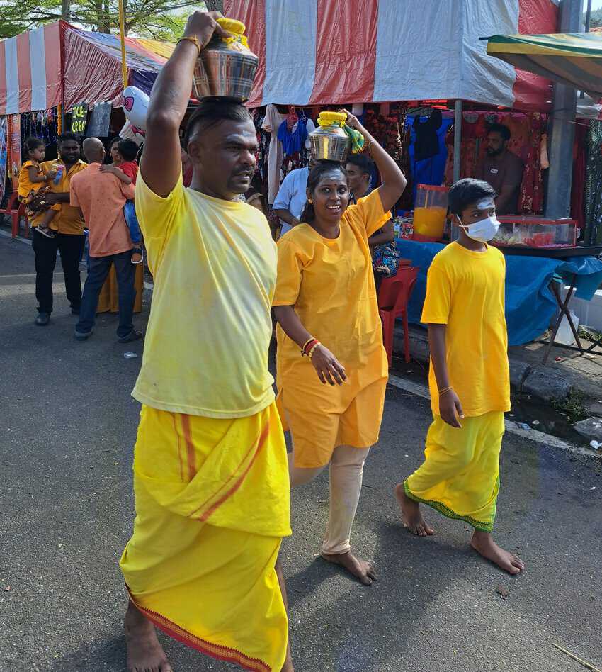 Devotees carry milk pots on their heads