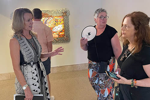 Audrey Eden, Art Museum docent in black & white dress, explaining it all