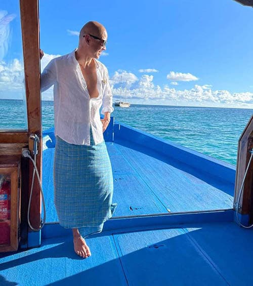 Hong Kong-based travel writer, Kee Foong rocks a blue sarong on a boat in The Maldives.
