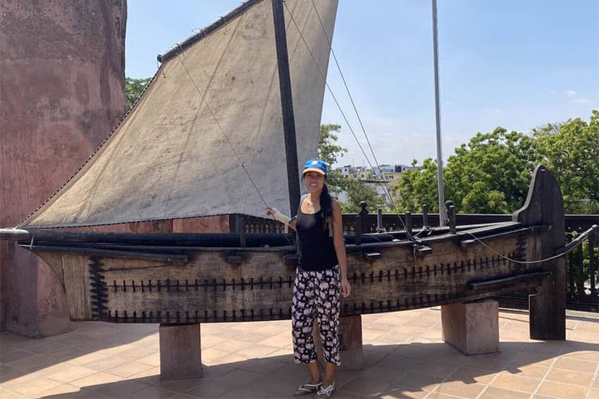A mini replica of a dhow, a traditional Arab ship, stood at the entrance to the Oman House. Author Annie Chen