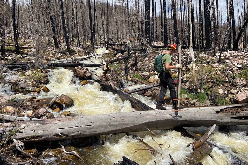 Crossing a creek newly re-routed due to the effects of the East Fork Fire & unusually high snow melt, High Uintas Wilderness, UT.