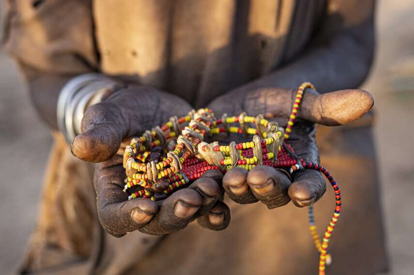 An older woman from the Hamar tribe in Ethiopia’s Omo Valley peddles unique bracelets and necklaces produced by the women in her tribe.