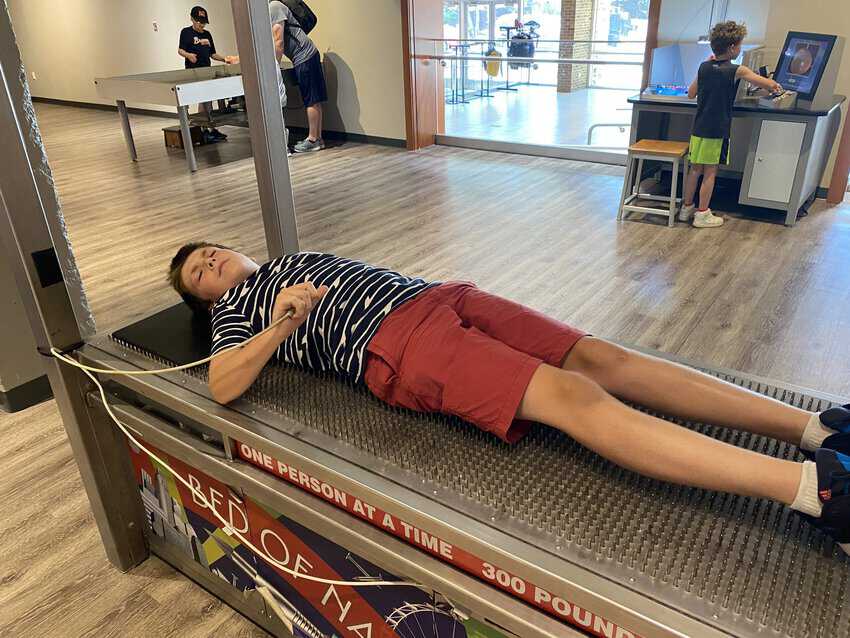 Little Rock Arkansas: What's The Danger? 2 Trying out the bed of nails at the Museum of Discovery in Little Rock.