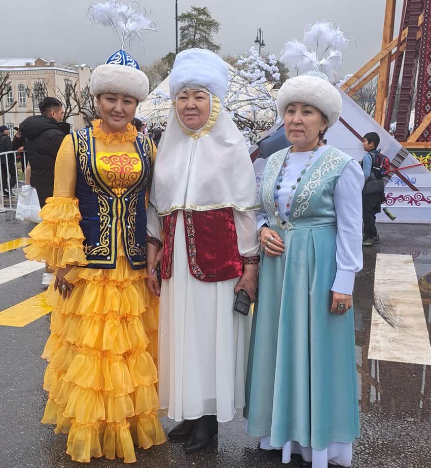 Kyrgyzstan: Where Hospitality Meets Untamed Beauty 3 People in traditional costumes at the Nowruz celebration