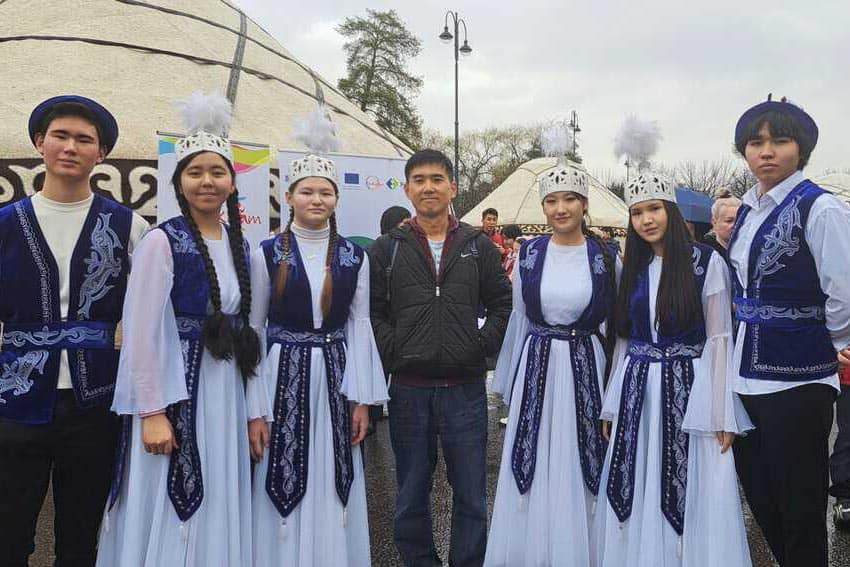 Kyrgyzstan: Where Hospitality Meets Untamed Beauty 9 The writer, Teh Chin Liang, poses with a group of costumed Nowruz revelers