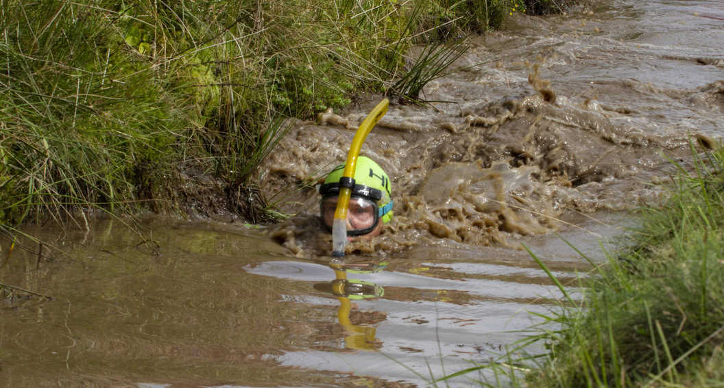 A contestant snorkels his way through the bog