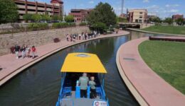 People and boats on Pueblo's Riverwalk