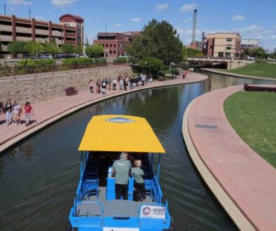 People and boats on Pueblo's Riverwalk