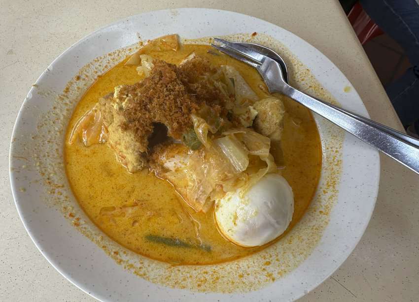 This version of Lontong, a dish which originated in South India and Sri Lanka, features compressed rice cakes, a soft-boiled egg, and toasted coconut in a coconut curry sauce. Photo by Donnie Sexton