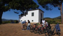 a group of people standing outside a buildingUnder the pines at La Cabaña de los Pinos.