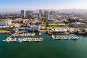 Stunning aerial view of Jack London Square, showcasing the vibrant waterfront, bustling docks, and surrounding urban landscape.