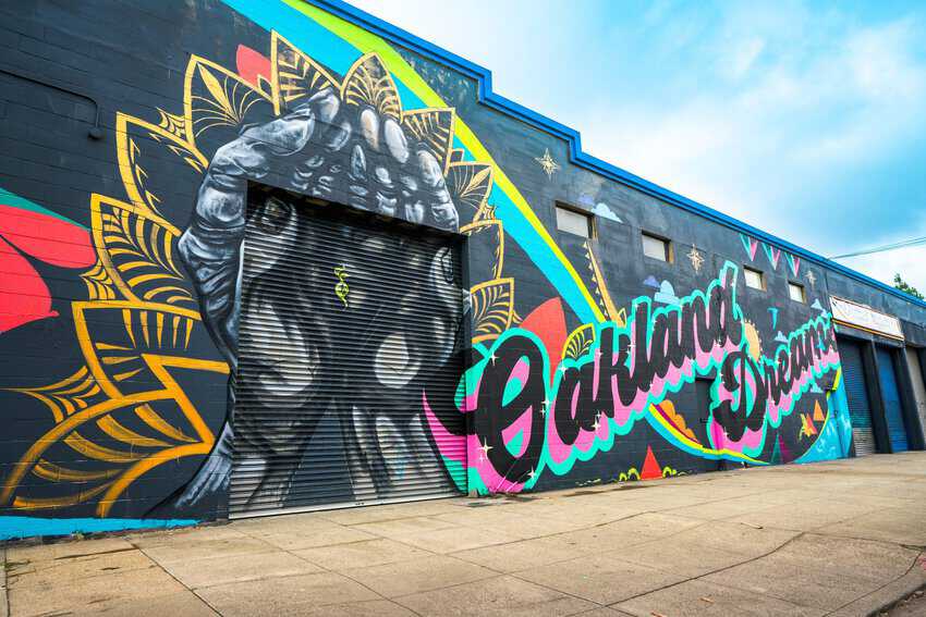 Oakland: Discover the City's Unique Neighborhoods and Cultural Heritage 17 Stunning mural displaying the words 'Oakland Dreams,' highlighting the creative vibe at the Oakland Mural Festival.