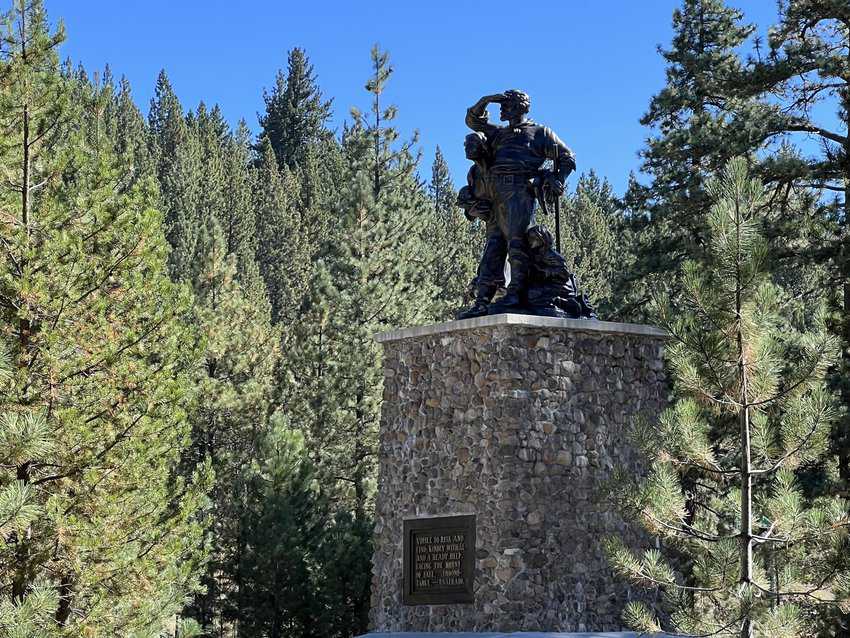 North Lake Tahoe, California 9 Bronze Image of family looking in the distance atop a stone pedestal surrounded by pine trees and blue sky