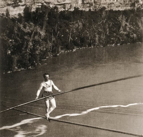 Man balancing on a tightrope above Niagara river
