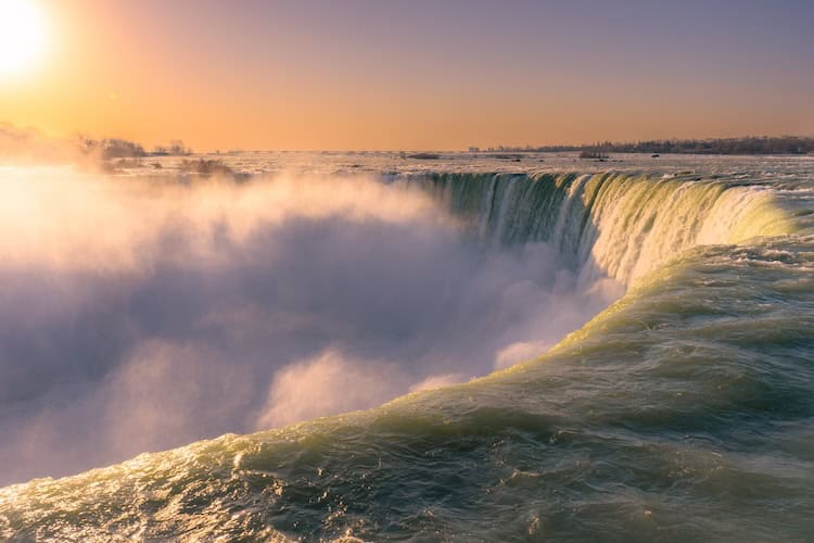 a large waterfall with a large body of water