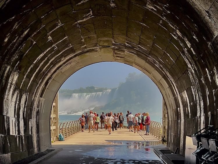 a group of people standing on an observation platform outside the Power Station Tunnel 
