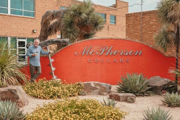Lubbock: Surprising Hub of Creativity and Wine 1 Kim McPherson poses in front of McPherson Cellars. Photo: Visit Lubbock