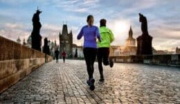 Joggers go for a morning run on Prague's Charles Bridge.