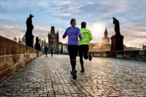 Joggers go for a morning run on Prague's Charles Bridge.